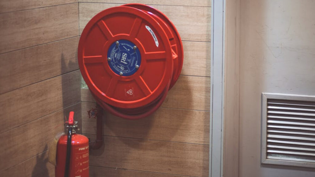 What to Expect During a Professional Fire Risk Assessment in London 1 Fire safety equipment including hose reel and extinguisher used in fire risk assessment services London