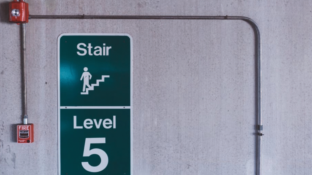 Fire safety inspection London – emergency stair signage and fire alarm system in a commercial building