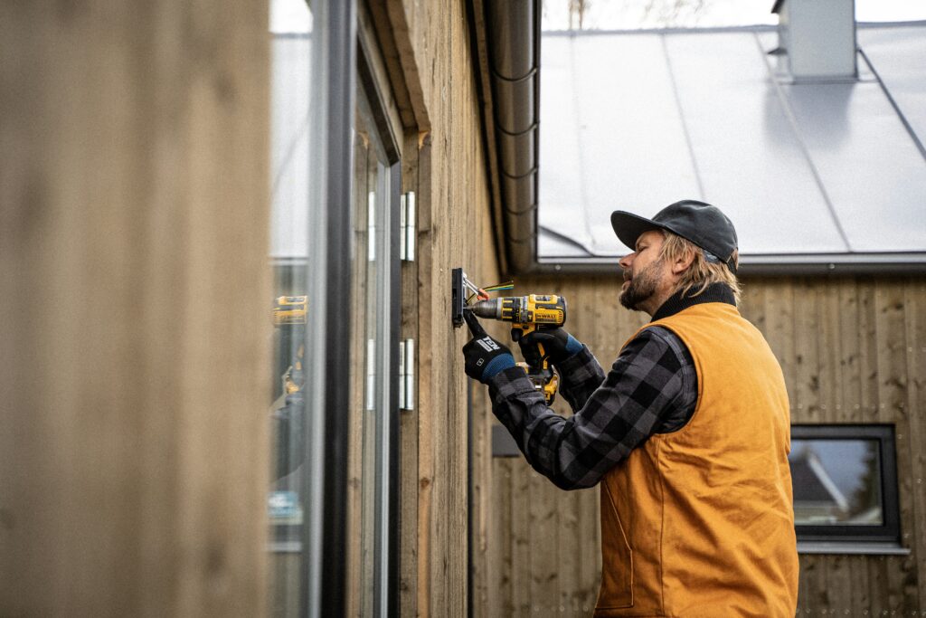 EICR London: What Every Homeowner and Landlord Needs to Know in 2025 2 Budget PAT Testing technician conducting electrical safety checks in a Camden flat as part of a certified EICR London service.