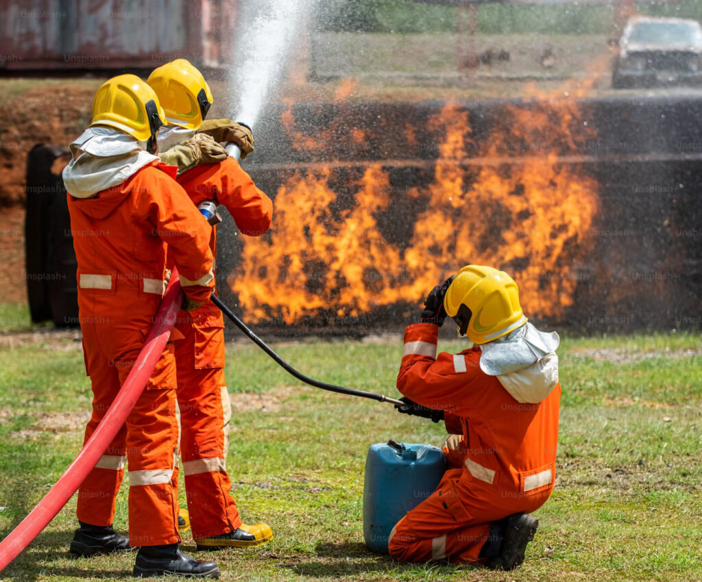 Do I Need a Fire Risk Assessment for My London Property? 1 Firefighters in protective gear extinguishing a controlled blaze during a fire safety training in London