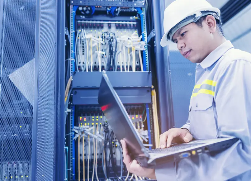 EICR Report London Explained: Codes, Costs & Next Steps 1 Engineer explaining EICR report London results to a homeowner after a safety inspection.