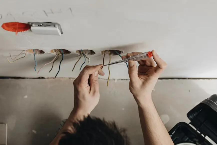 EICR Cost London: 2025 Smart Pricing Guide for Homes & Rentals 2 EICR cost London service by Budget PAT Testing technician inspecting a fuse board in a North London property.